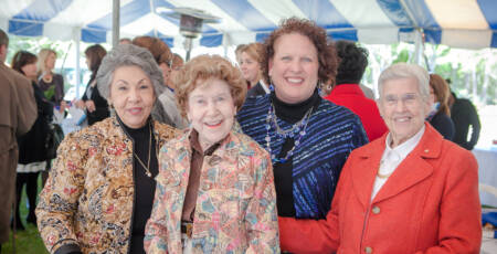 group of smiling women at event