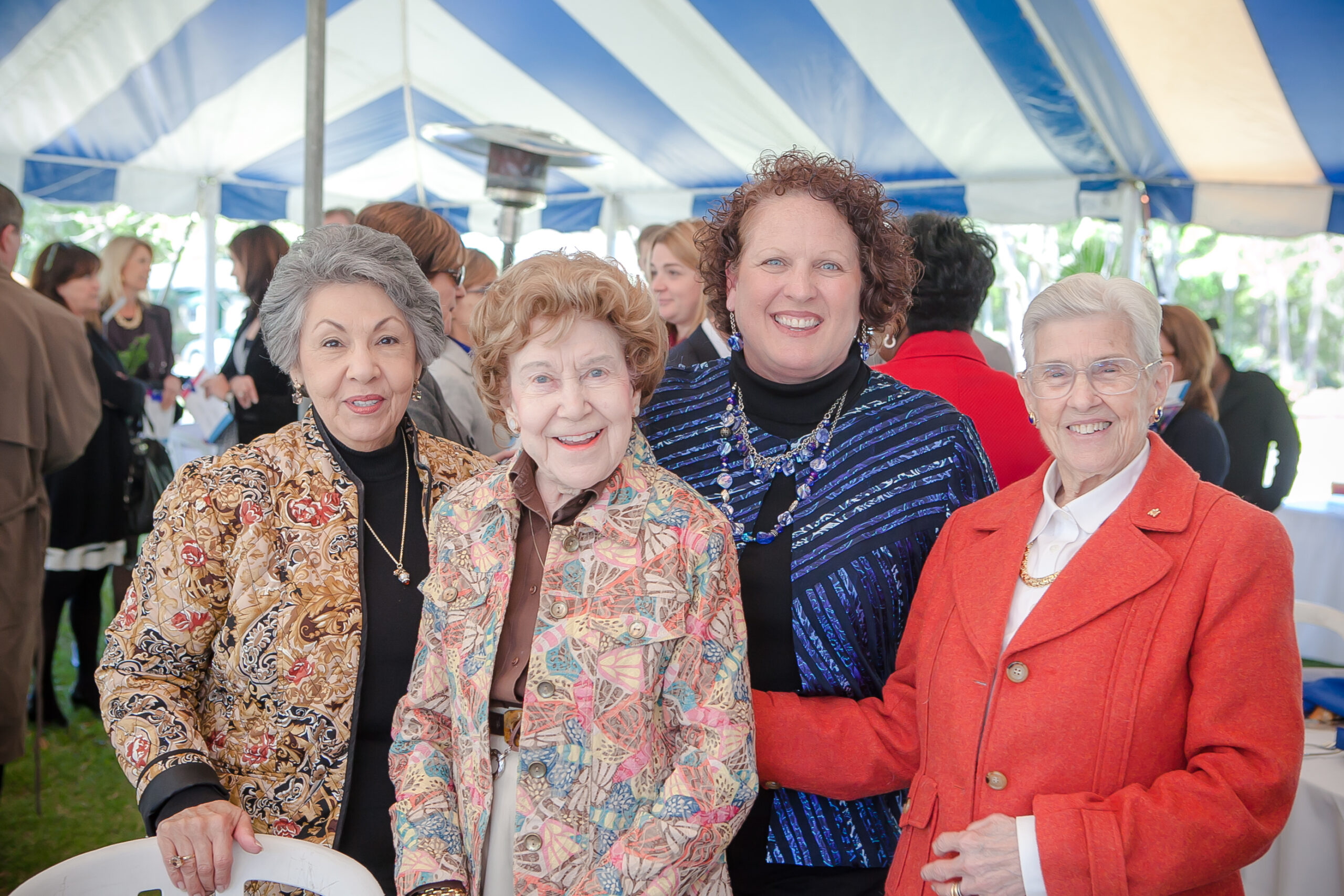 group of smiling women at event