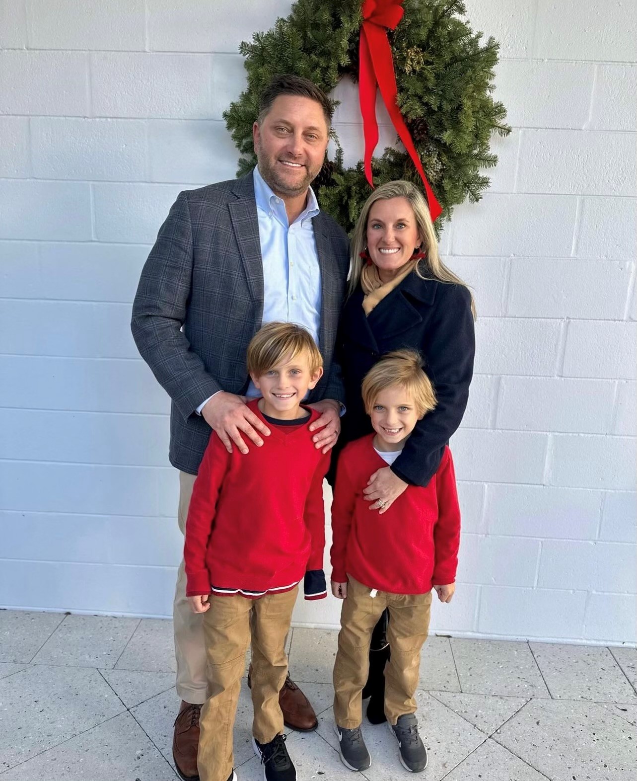 Brian Crooke and wife smile with two young boys