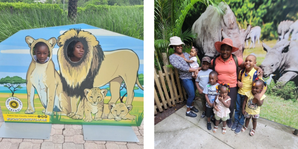 a mother and son pose with their heads inside lion cutouts. A group gathers in a front of a picture of rhinos.