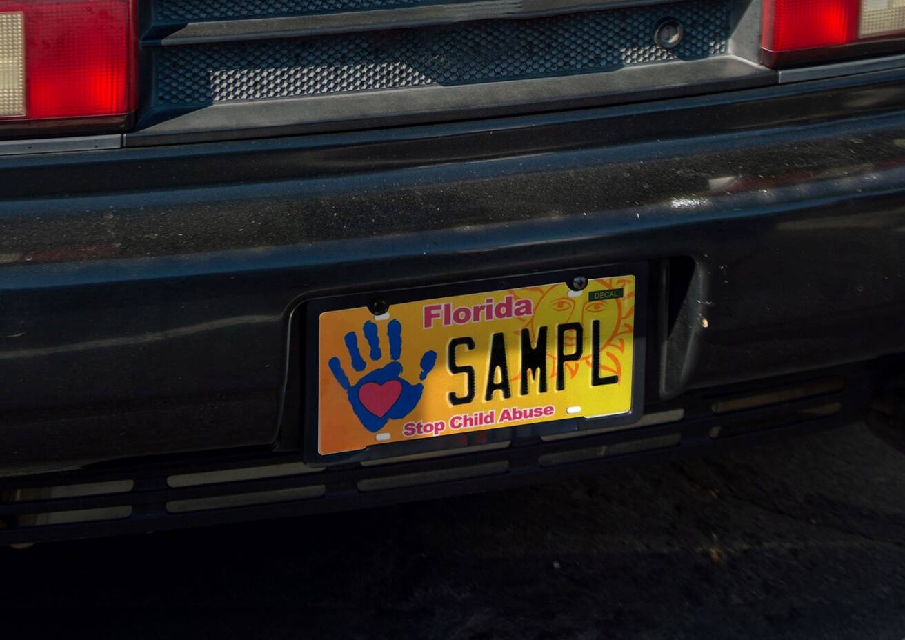 black car with Stop Child Abuse License Plate