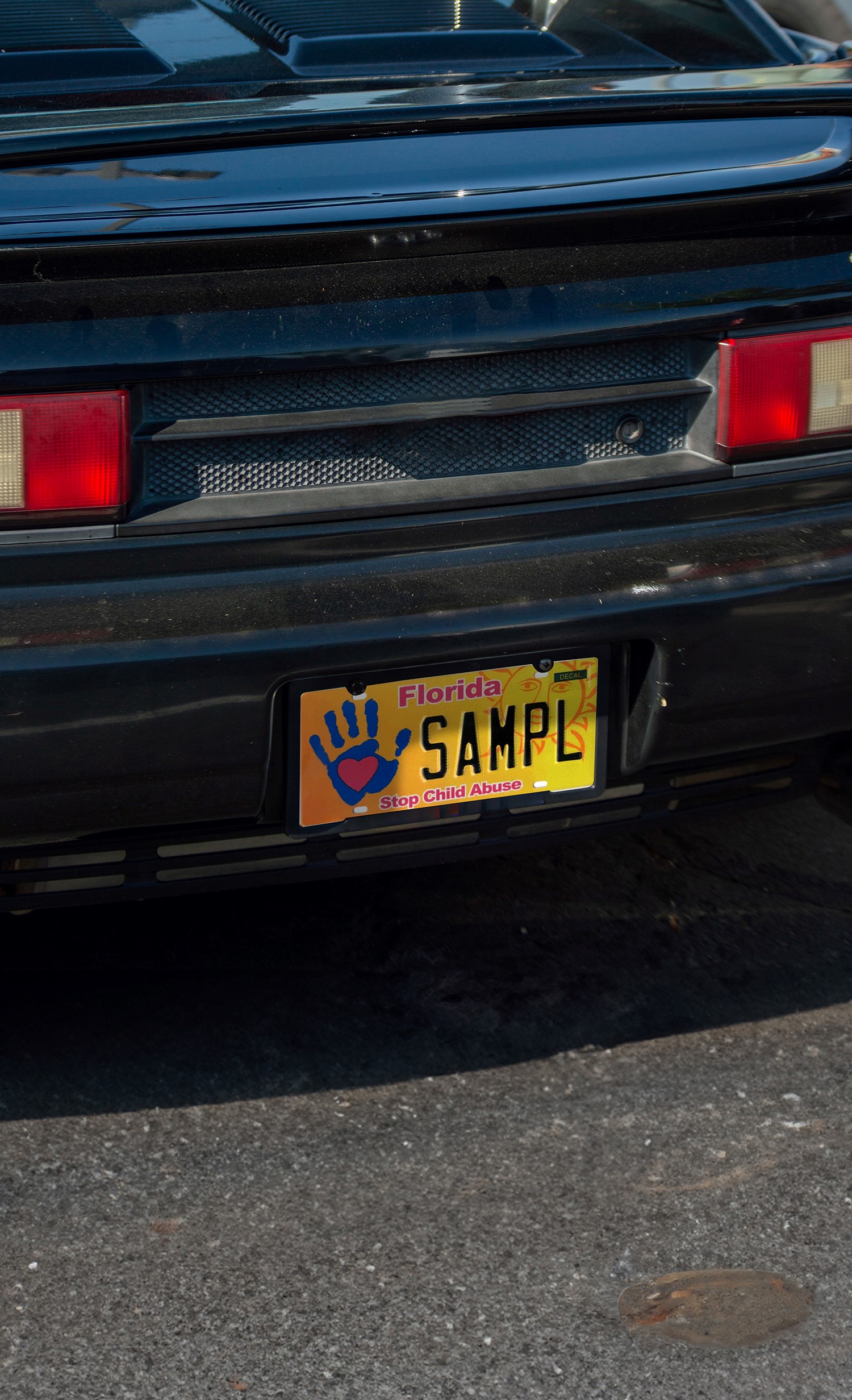 black car with Stop Child Abuse License Plate