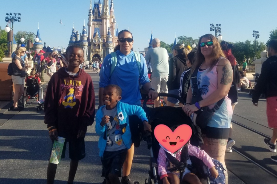 family standing in front of castle at Magic Kingdom 