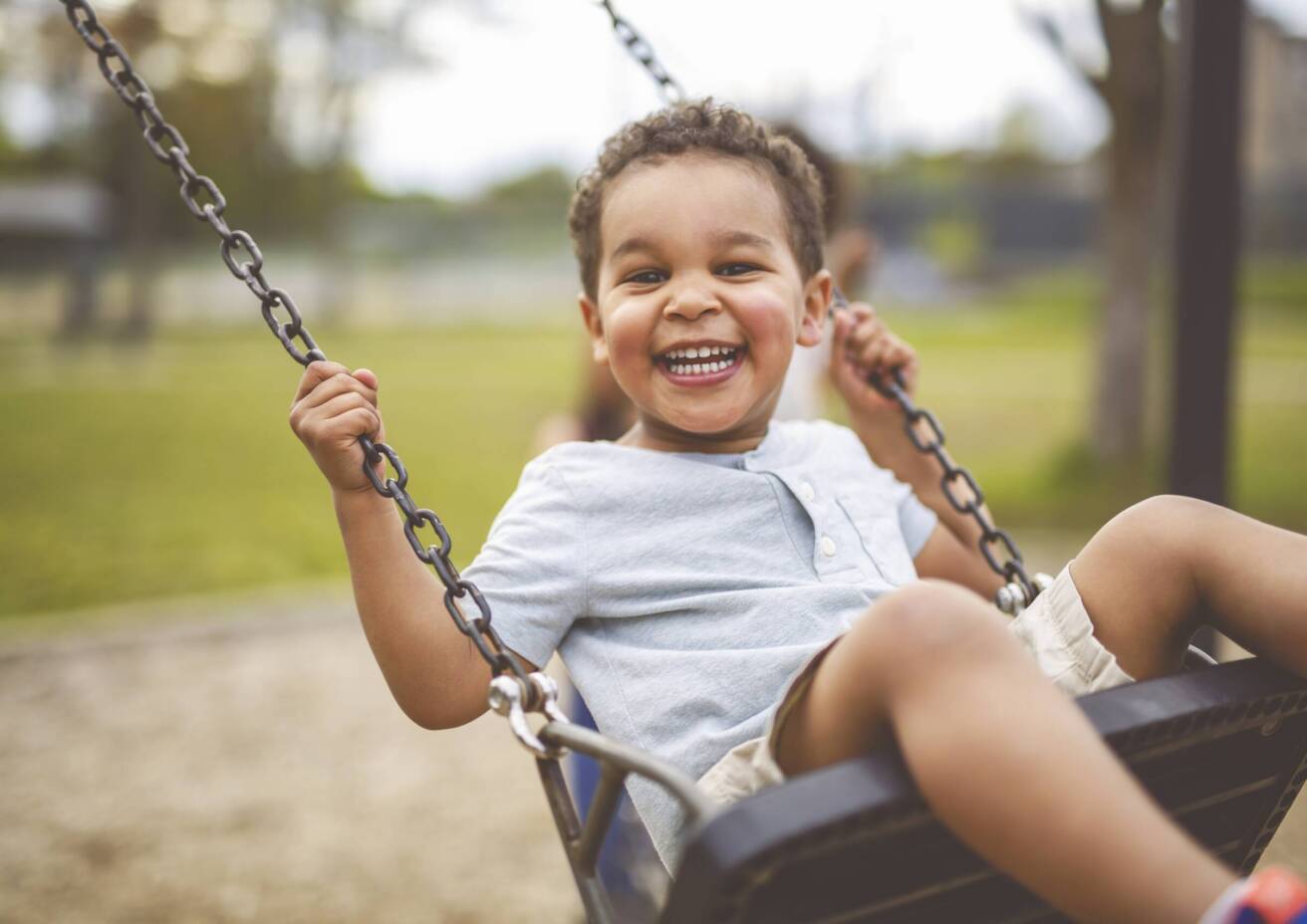 Little boy swinging on a swing