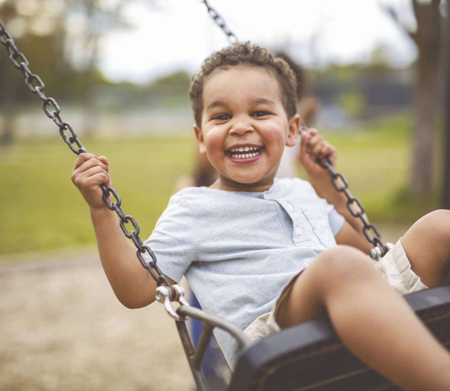 Little boy swinging on a swing