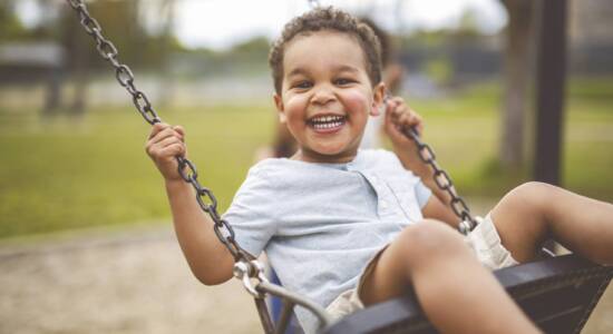 Little boy swinging on a swing