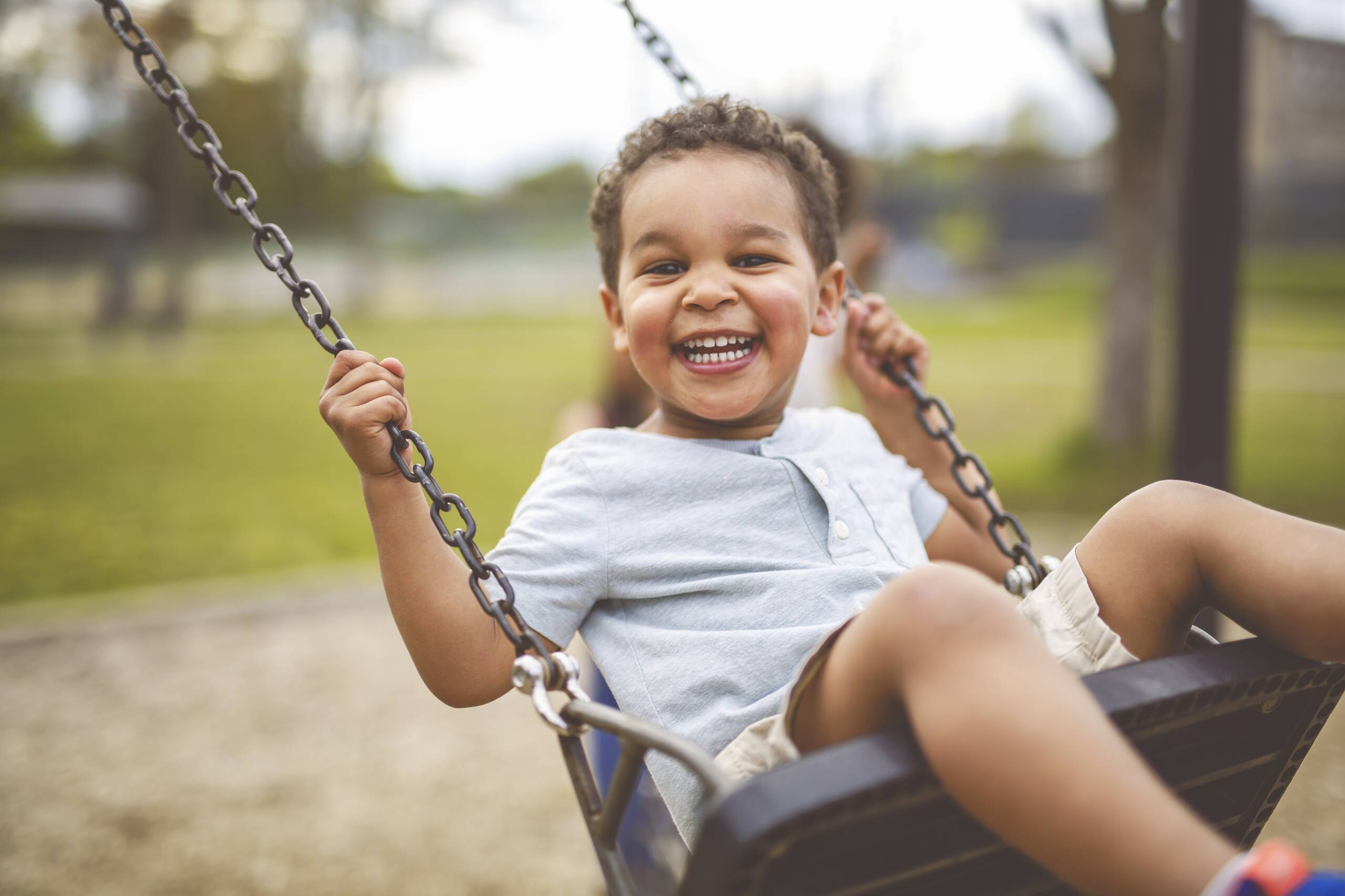 Little boy swinging on a swing